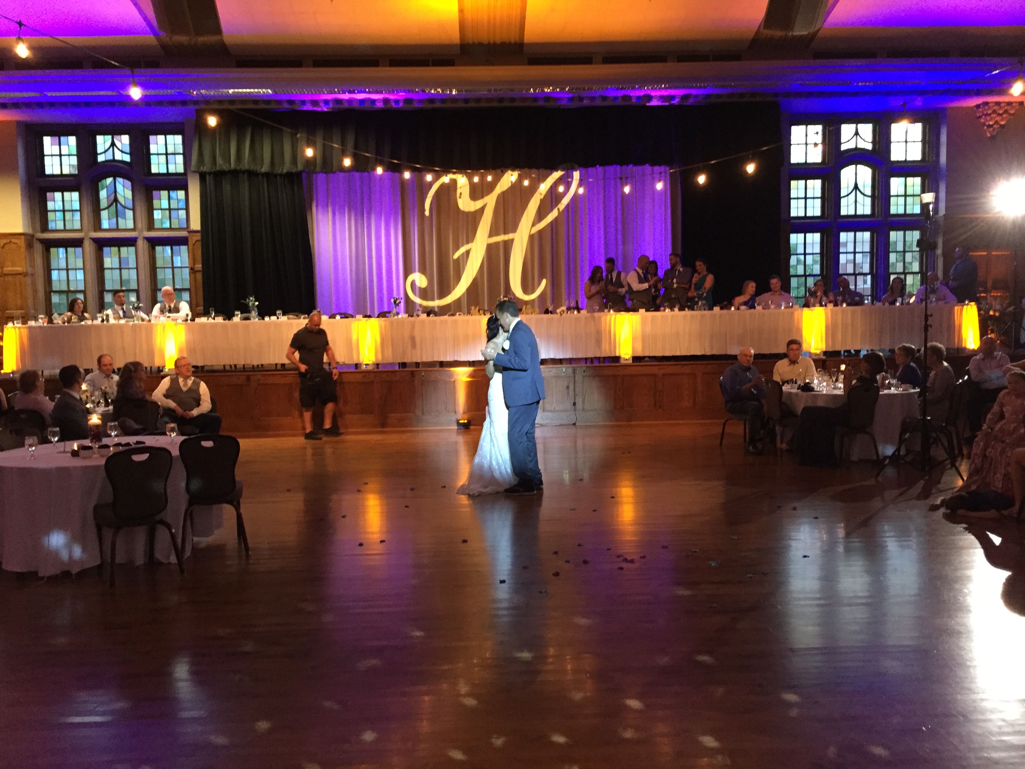 Grand ballroom with H monogram projection and purple uplighting