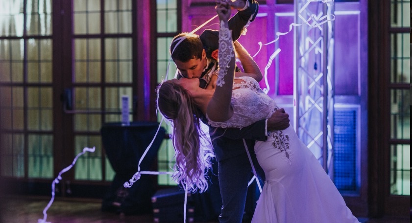Intimate wedding moment with purple uplighting